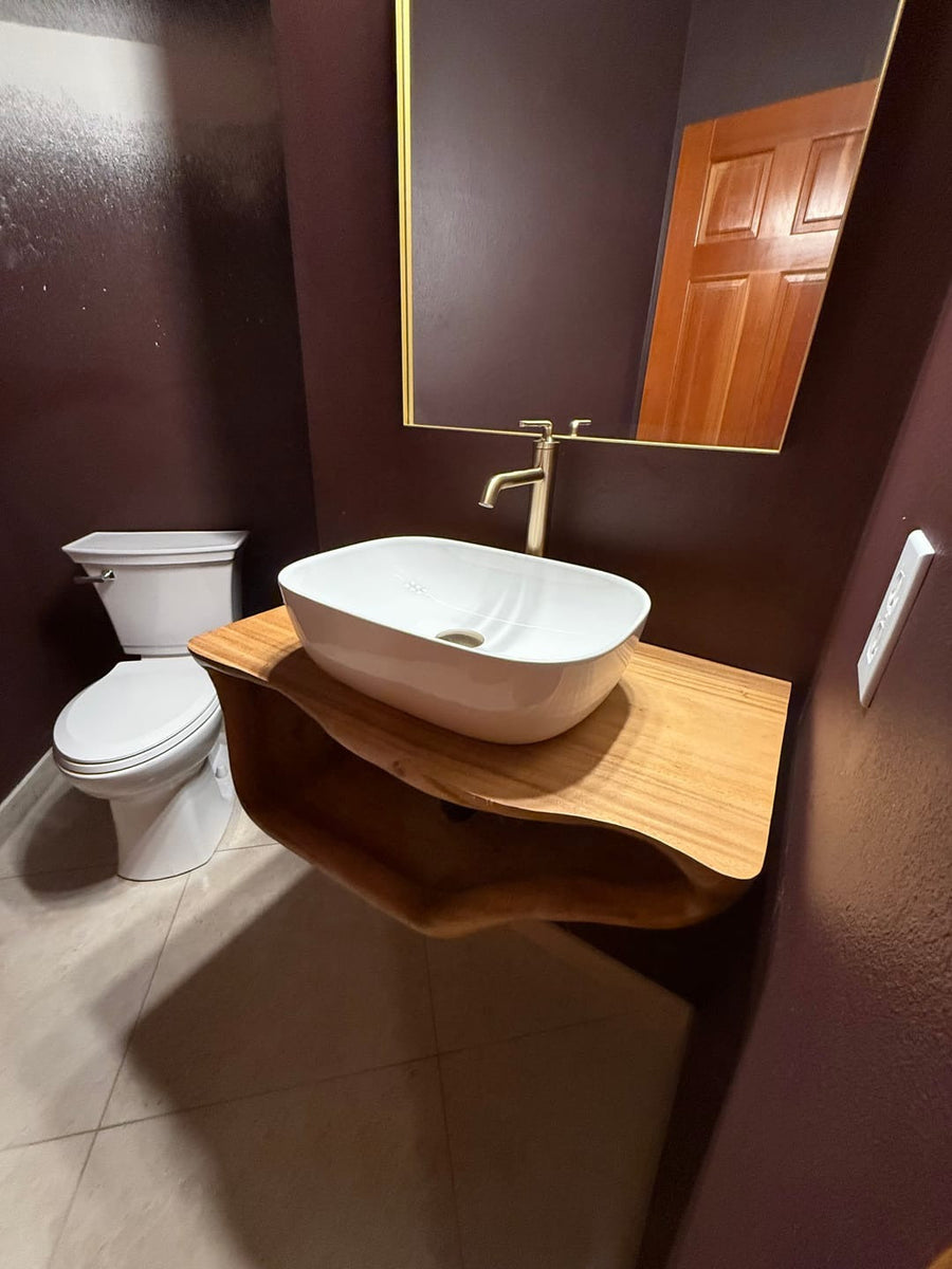 Floating solid wood bathroom vanity with a white vessel sink in a powder room