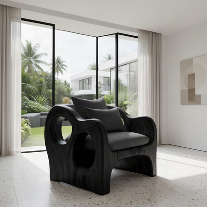 Rondel sculptural wood lounge chair in Black with circular side cutouts and charcoal cushions in a bright room