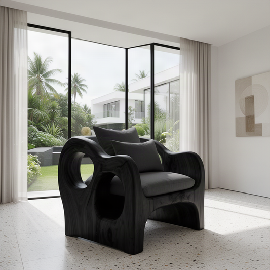 Rondel sculptural wood lounge chair in Black with circular side cutouts and charcoal cushions in a bright room