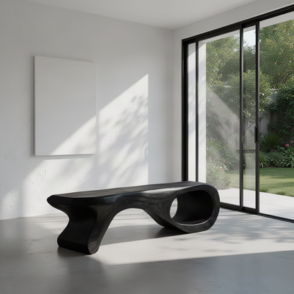 Spirela sculptural wood bench in Black with curled loop end and tapered support in a sunlit minimalist room