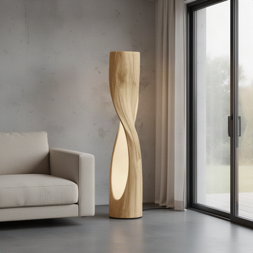 Torsiva sculptural wood floor lamp in Oak with twisting column and warm glow from a carved opening beside a sofa