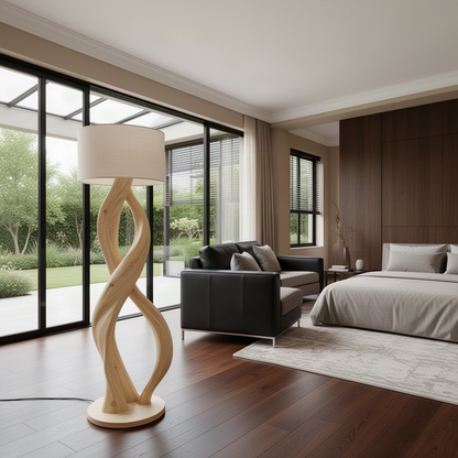 Entwina Oak sculptural floor lamp beside a leather sofa in a bright open-plan living room with garden views