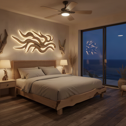Solvane sculptural wood wall art in Oak with flowing driftwood branches softly backlit above a bed in a coastal bedroom