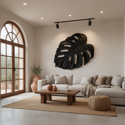 Monsteria sculptural wood wall art in Black, a carved monstera leaf on a light feature wall
