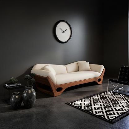 Navira curved wood base sofa with cream upholstery styled with accent pillows in a calm organic modern lounge