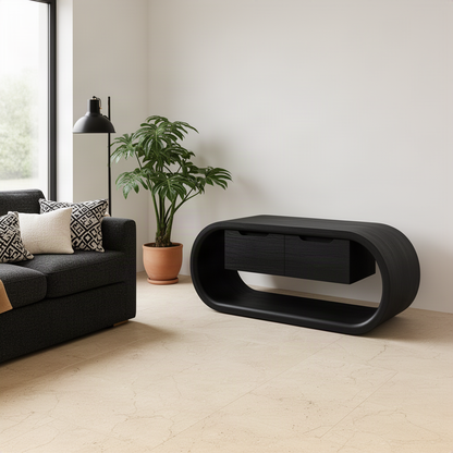 Ovalis sculptural TV stand in Black solid wood with a rounded loop frame and hidden drawers in a modern minimalist room