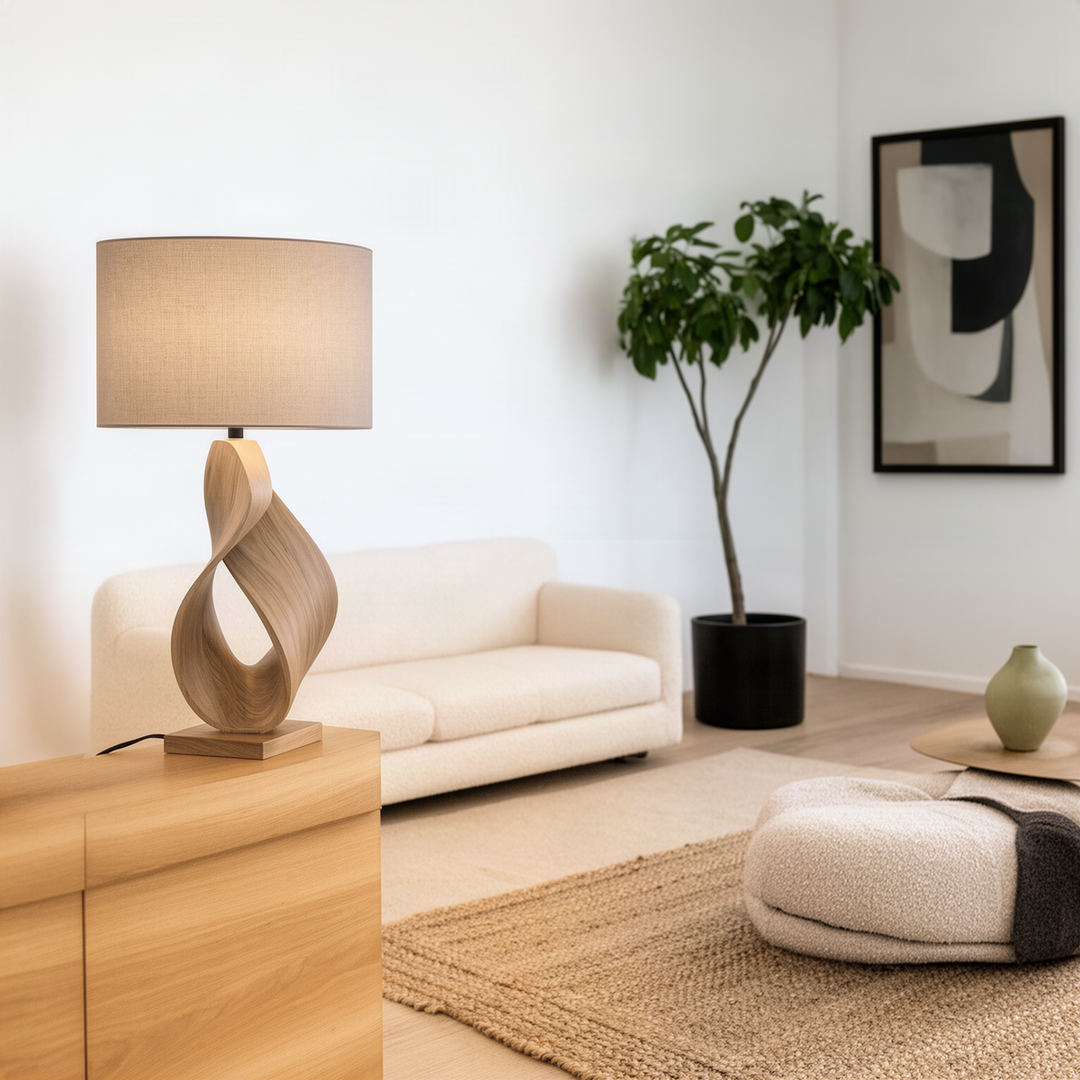 Infinia table lamp in Natural solid wood with a twisted ribbon base and fabric drum shade in a bright living room