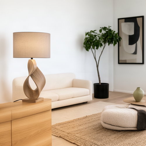 Infinia table lamp in Natural solid wood with a twisted ribbon base and fabric drum shade in a bright living room