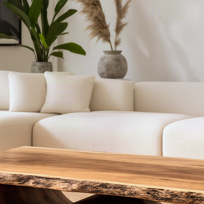 Close-up of the Tavira coffee table showing the natural live edge, bark texture and rich wood grain on the slab