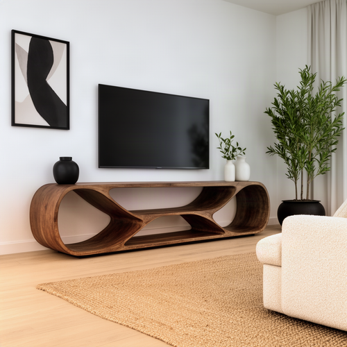 Arcella TV stand in solid wood, a long low curved frame media console with open cut-outs under a wall-mounted TV