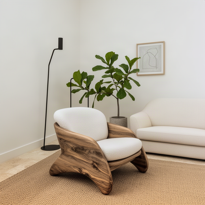 Embrella curved wood lounge chair seen from an angle beside a fiddle leaf fig and floor lamp