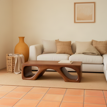 Cavora sculptural wood coffee table in brown with bridge-like profile and smooth carved tunnels