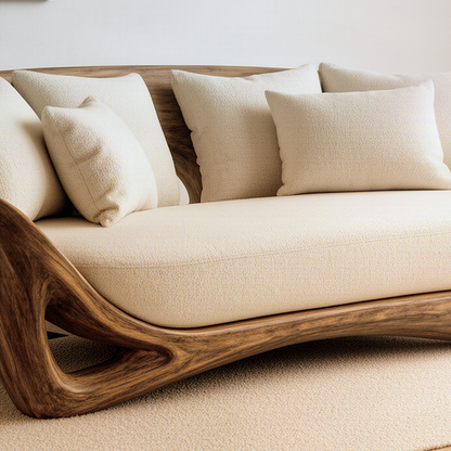Close-up of the Cocoona sofa showing the curved solid wood frame, open cutout and upholstered cushions