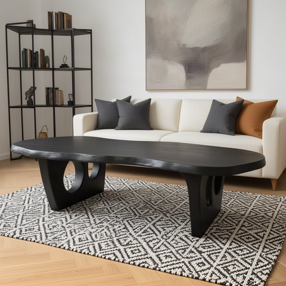 Pontara live edge wood coffee table in black on a patterned rug in front of a modern sofa