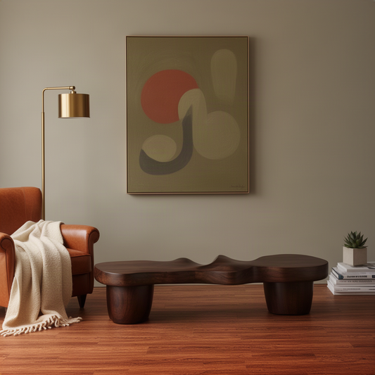 Undara sculptural wood bench in walnut finish, low organic slab bench beneath wall art beside a leather armchair