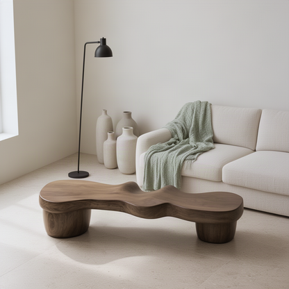 Undara organic wood bench seen at an angle in a calm living room, showing the rippled top and rounded pedestal legs